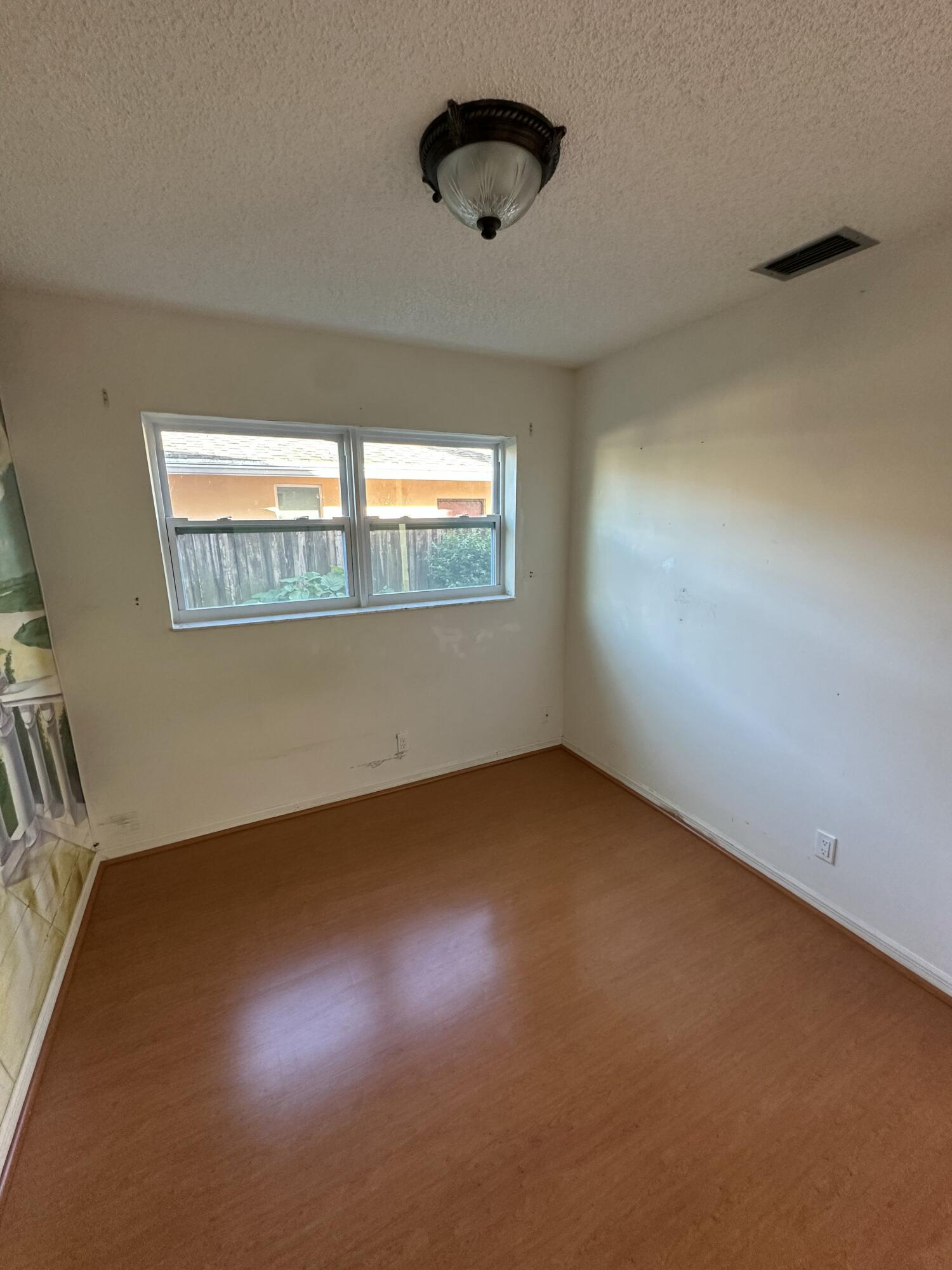3291 Southwest 4th Street Deerfield Beach, FL 33442 - Photo 13 of 38 an empty room with a window