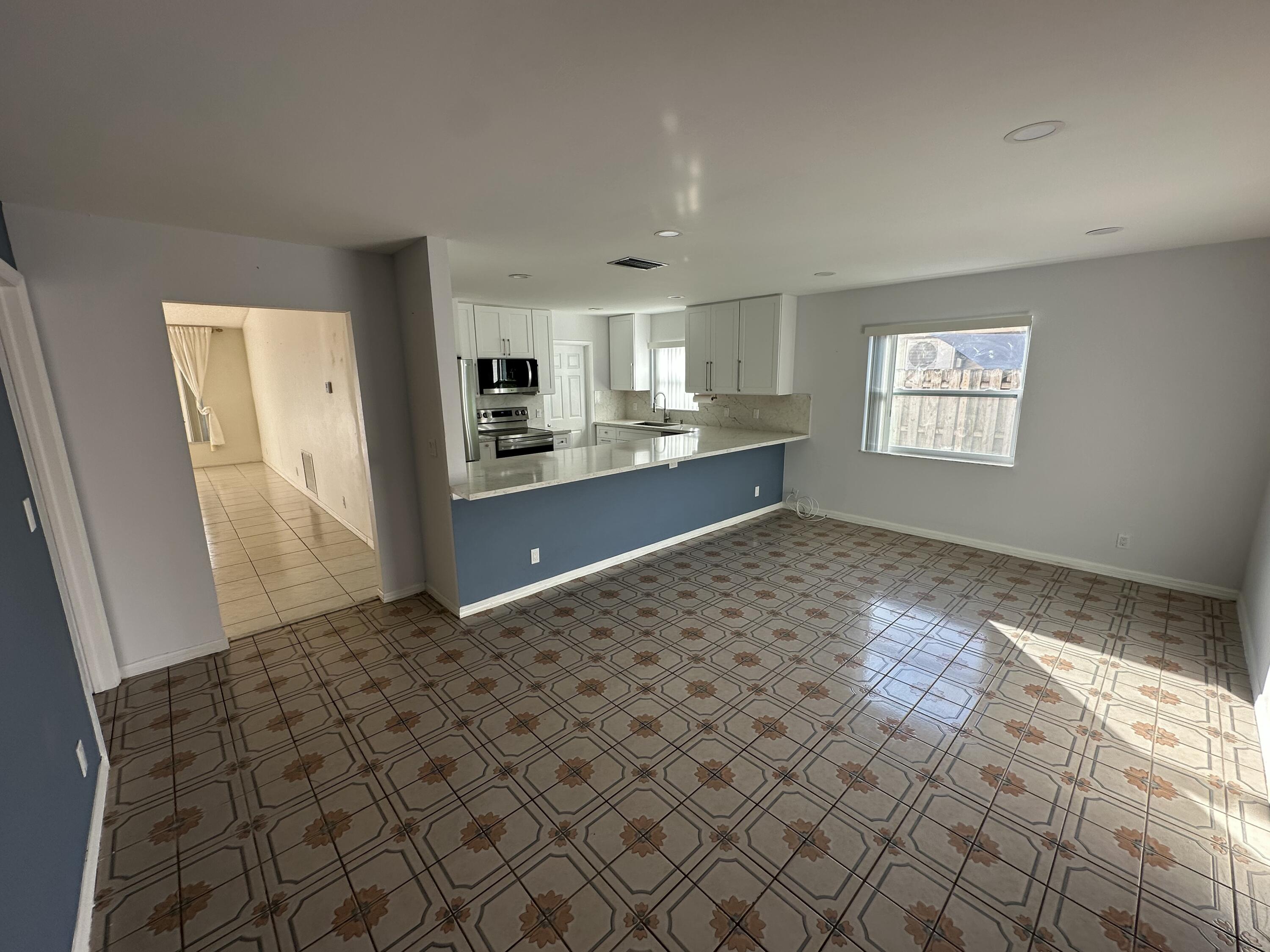 3291 Southwest 4th Street Deerfield Beach, FL 33442 - Photo 19 of 38 a big room with windows and cabinet