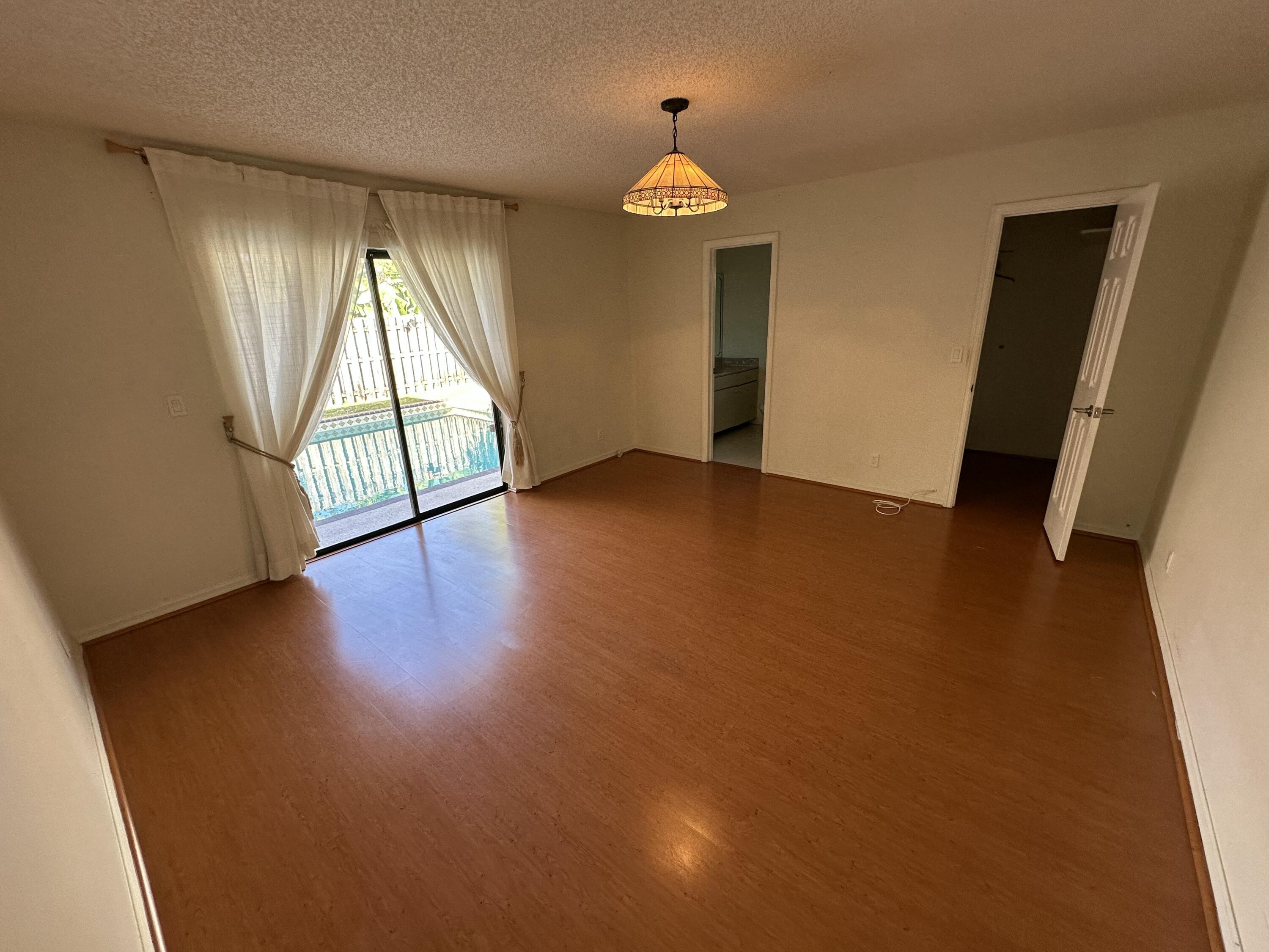 3291 Southwest 4th Street Deerfield Beach, FL 33442 - Photo 20 of 38 an empty room with wooden floor and windows