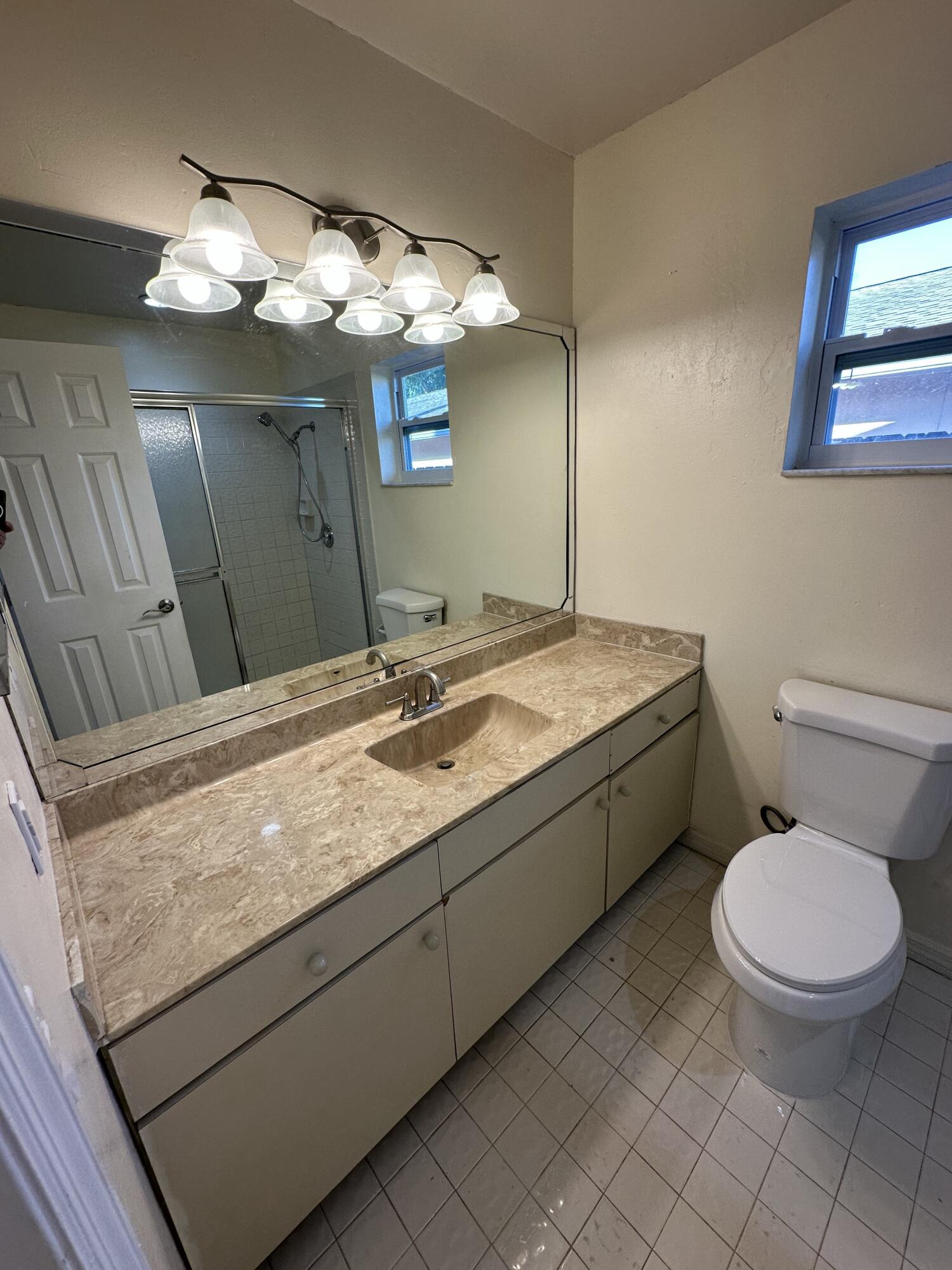 3291 Southwest 4th Street Deerfield Beach, FL 33442 - Photo 21 of 38 a bathroom with a granite countertop toilet sink and mirror
