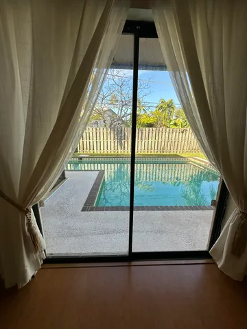 a backyard of a house with table and chairs
