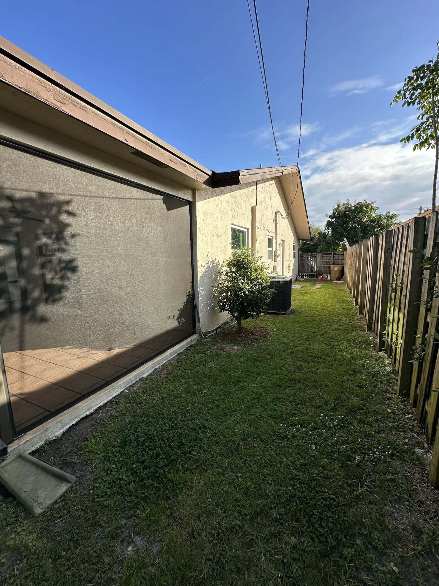 3291 Southwest 4th Street Deerfield Beach, FL 33442 - Photo 25 of 38 a backyard of a house with table and chairs