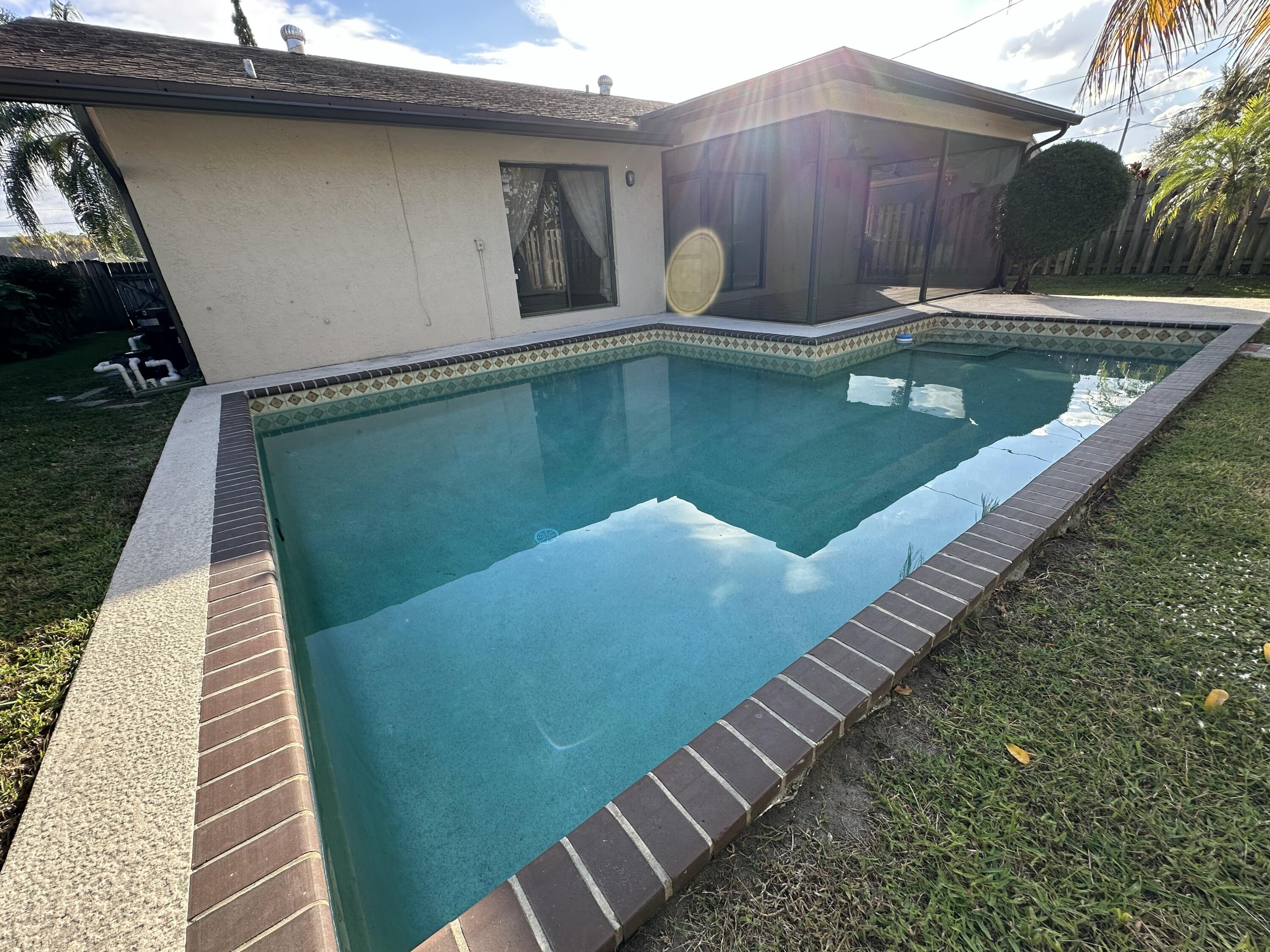 3291 Southwest 4th Street Deerfield Beach, FL 33442 - Photo 36 of 38 a view of a swimming pool with a patio