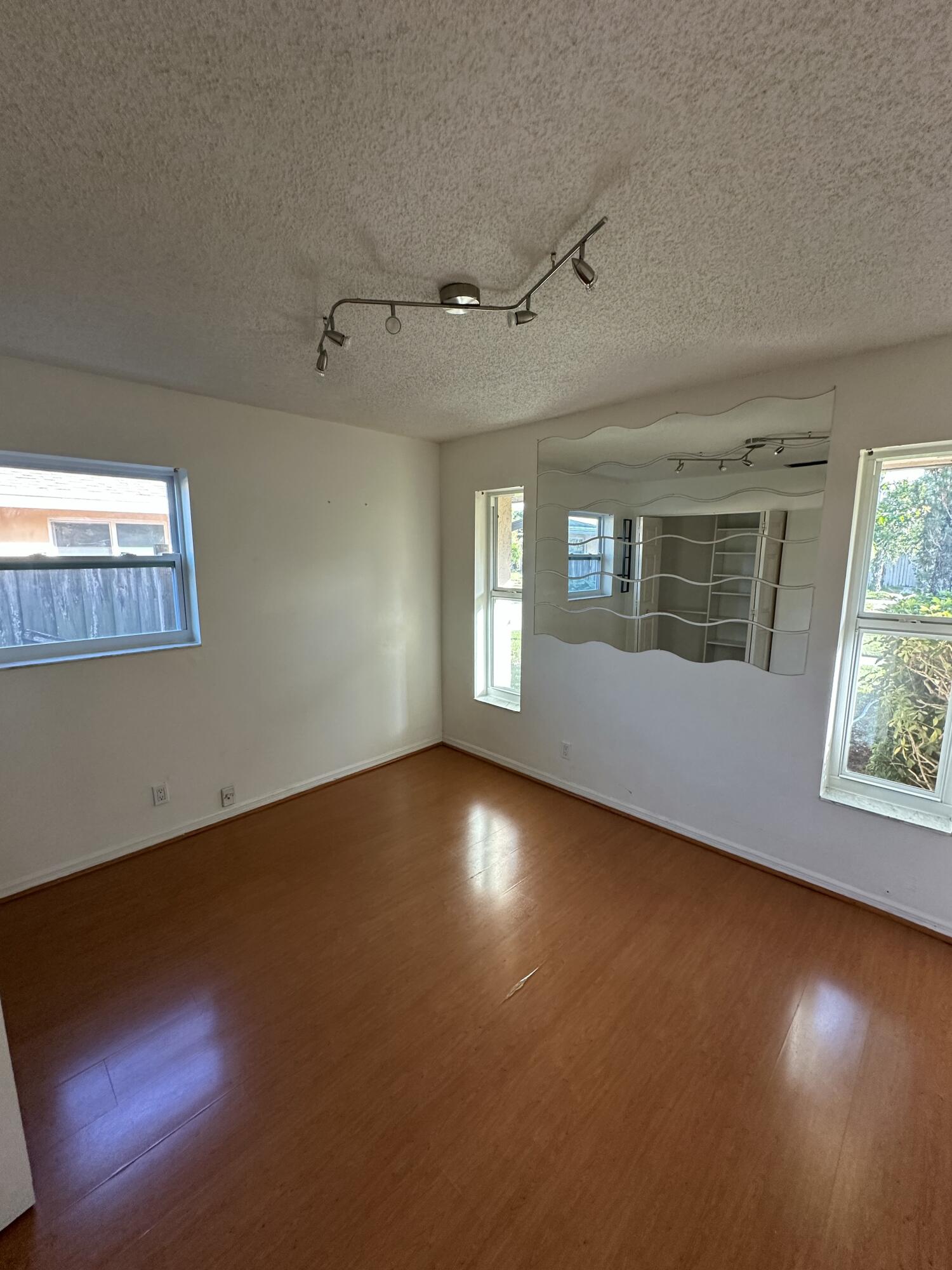 3291 Southwest 4th Street Deerfield Beach, FL 33442 - Photo 8 of 38 a view of an empty room with wooden floor and a window