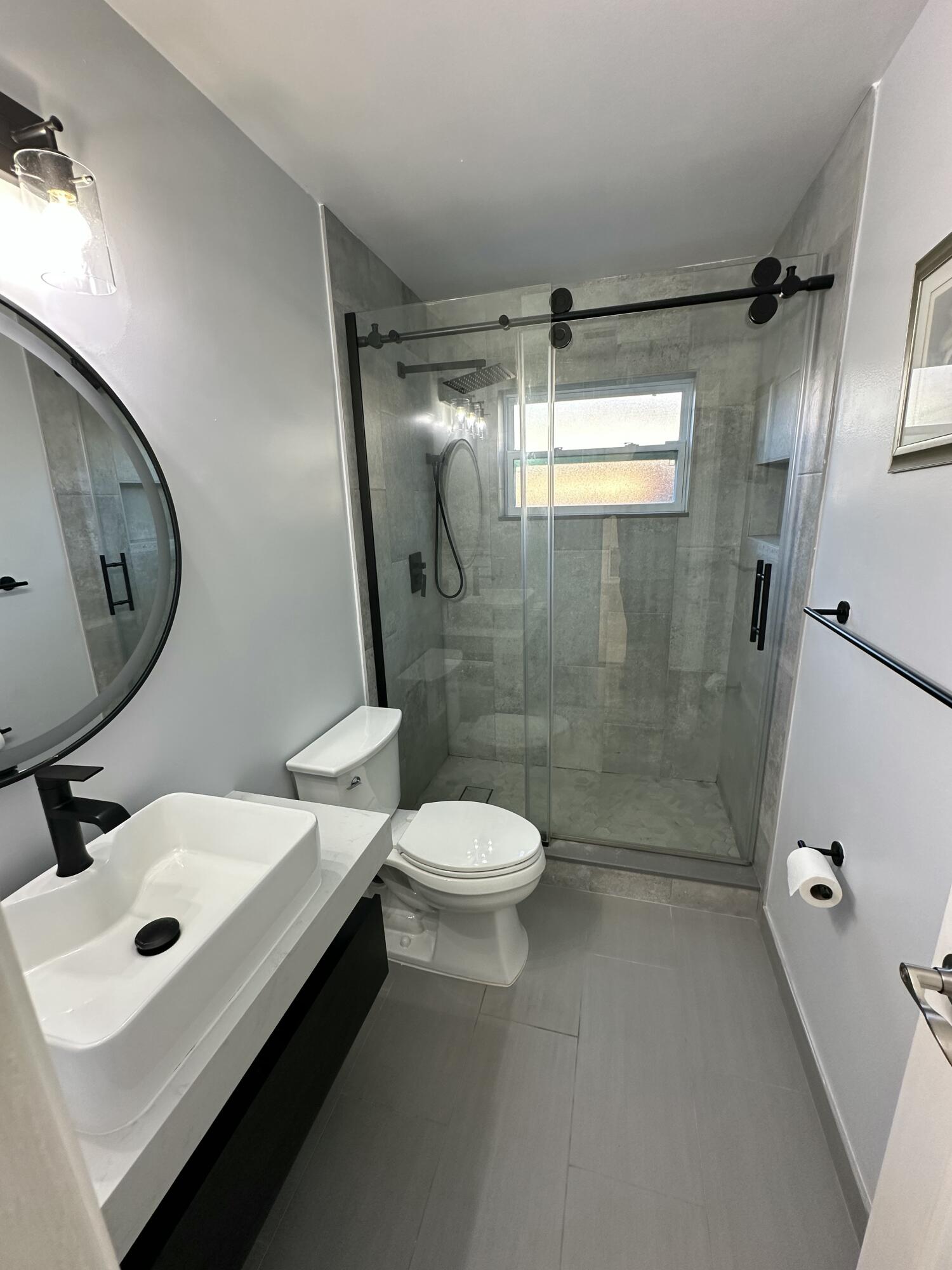 3291 Southwest 4th Street Deerfield Beach, FL 33442 - Photo 10 of 38 a bathroom with a sink toilet and shower