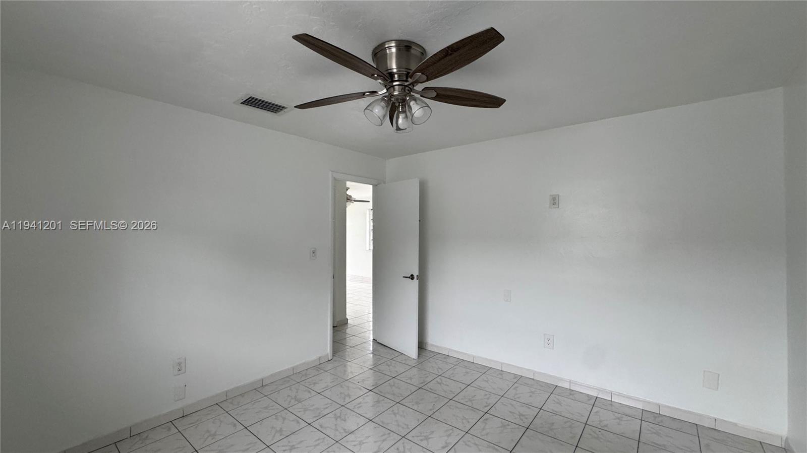 7235 Southwest 23rd Street, Unit 7235 Miami, FL 33155 - Photo 11 of 15 an empty room with windows and ceiling fan