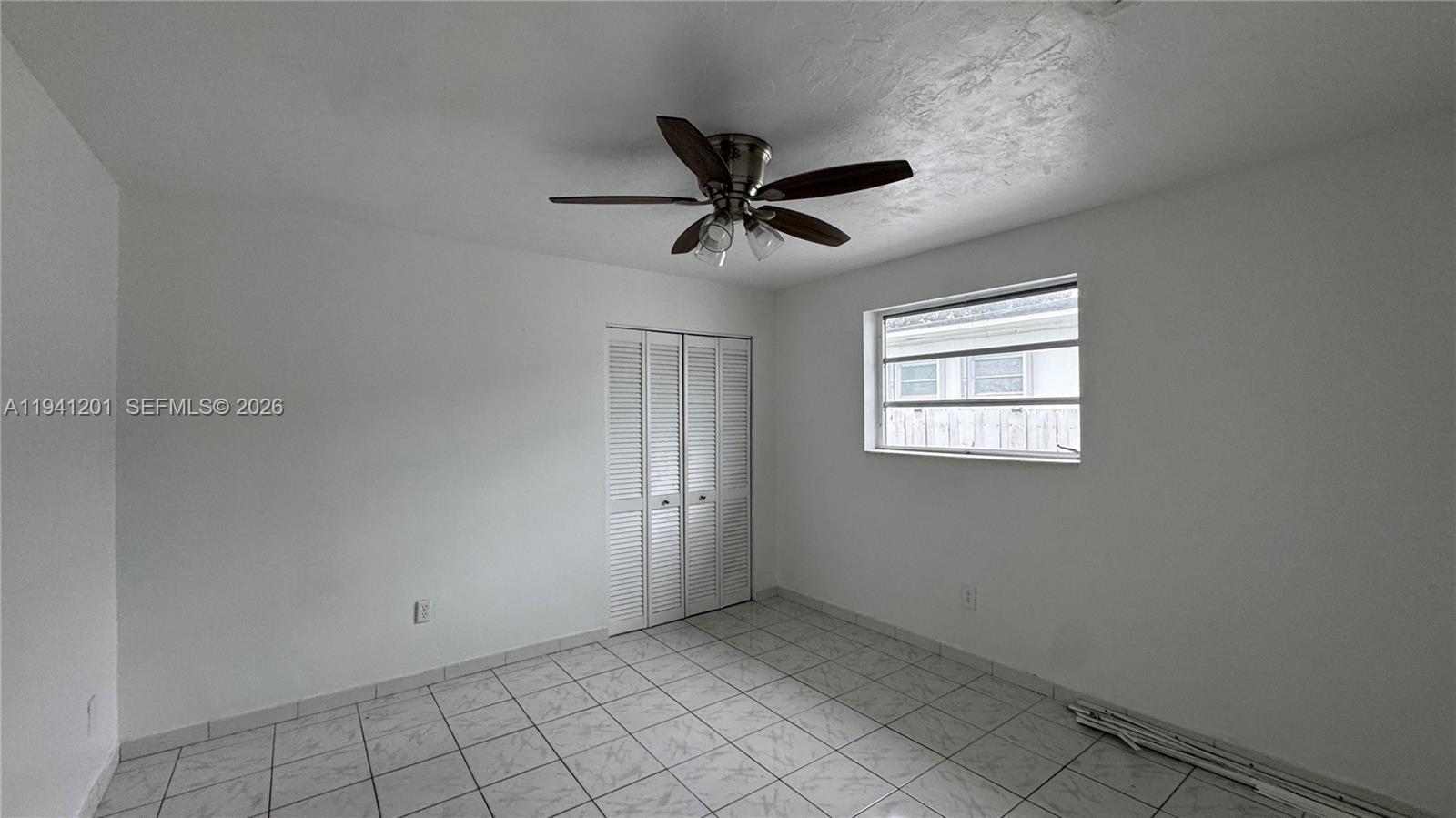 7235 Southwest 23rd Street, Unit 7235 Miami, FL 33155 - Photo 12 of 15 a view of a livingroom with a ceiling fan and window