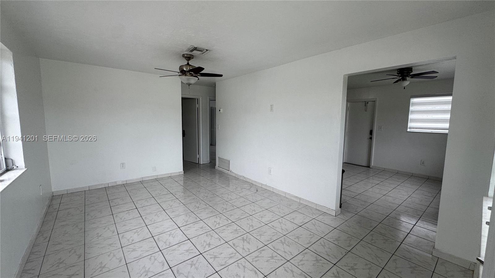 7235 Southwest 23rd Street, Unit 7235 Miami, FL 33155 - Photo 4 of 15 an empty room with windows and fan