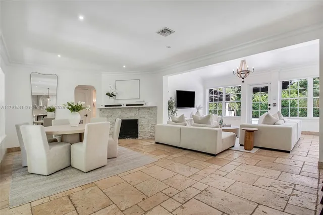 a view of a dining room with furniture and a fireplace