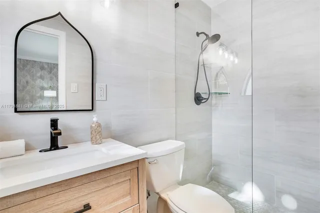 a bedroom with a bed wooden floor and window