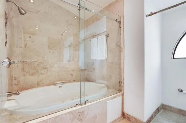 a bedroom with a bed and glass windows