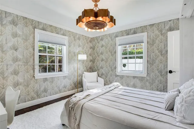 a living room with furniture a flat screen tv and a large window