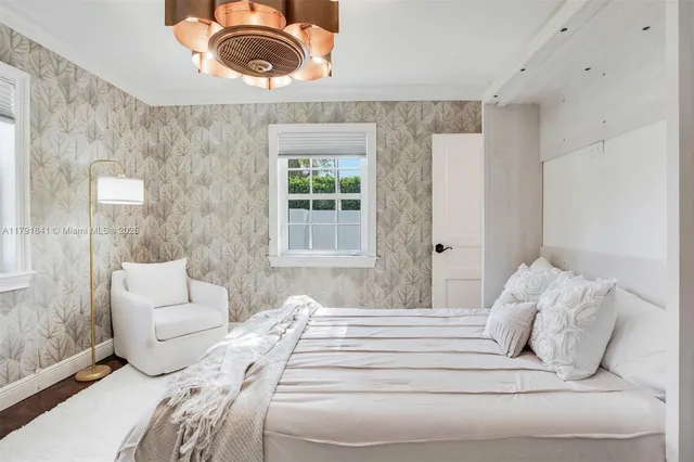 a large white bed in a white room