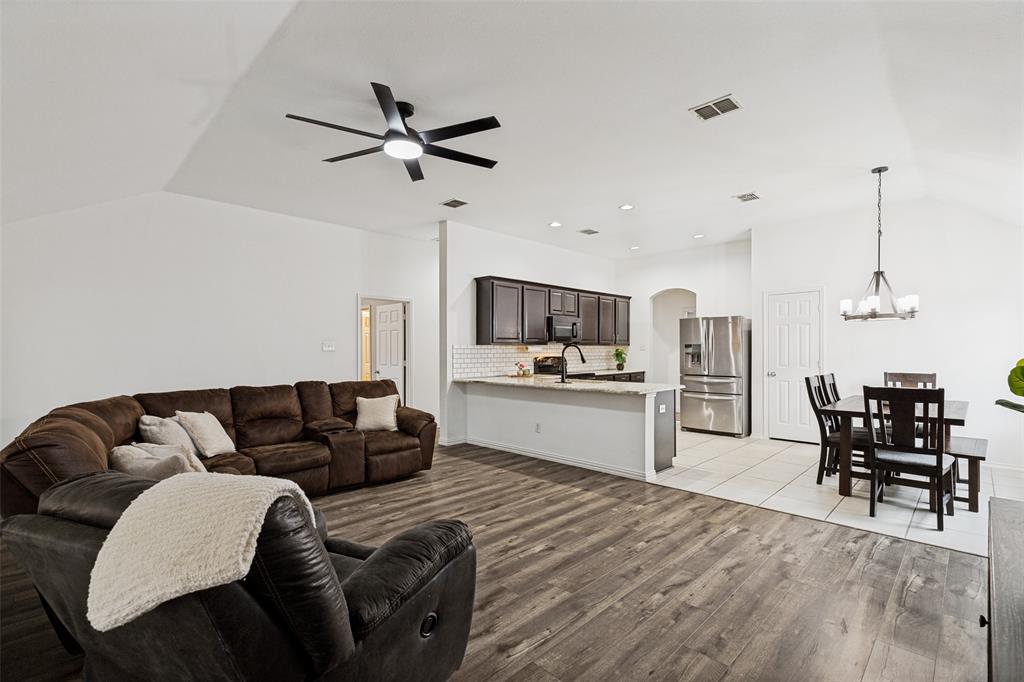 4305 Ridgewood Road Melissa, TX 75454 - Photo 10 of 26 Open-concept living area featuring wood-finish flooring and a vaulted ceiling