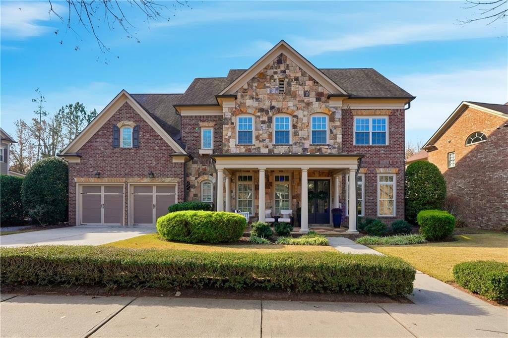 2139 McFarlin Lane Milton, GA 30004 - Photo 1 of 1 a front view of a house with a garden