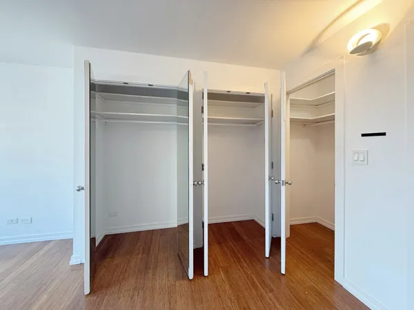 a room with wooden floor and closet