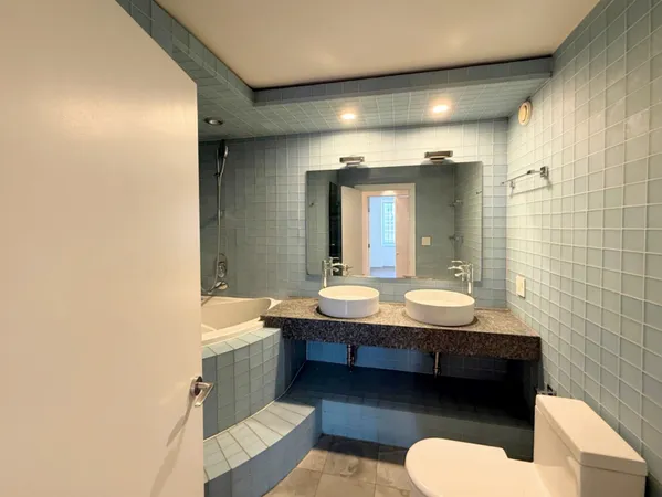 a bathroom with a sink a toilet and mirror