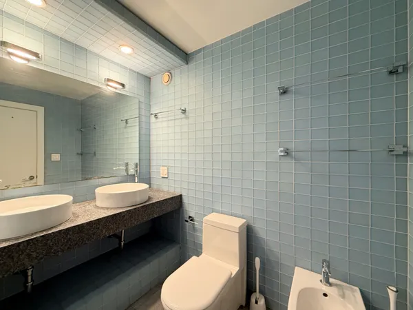 a bathroom with a double vanity sink toilet and mirror