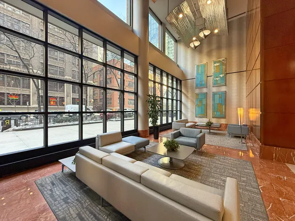 a living room with furniture and a floor to ceiling window