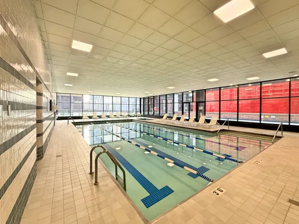 a view of a swimming pool and outdoor seating
