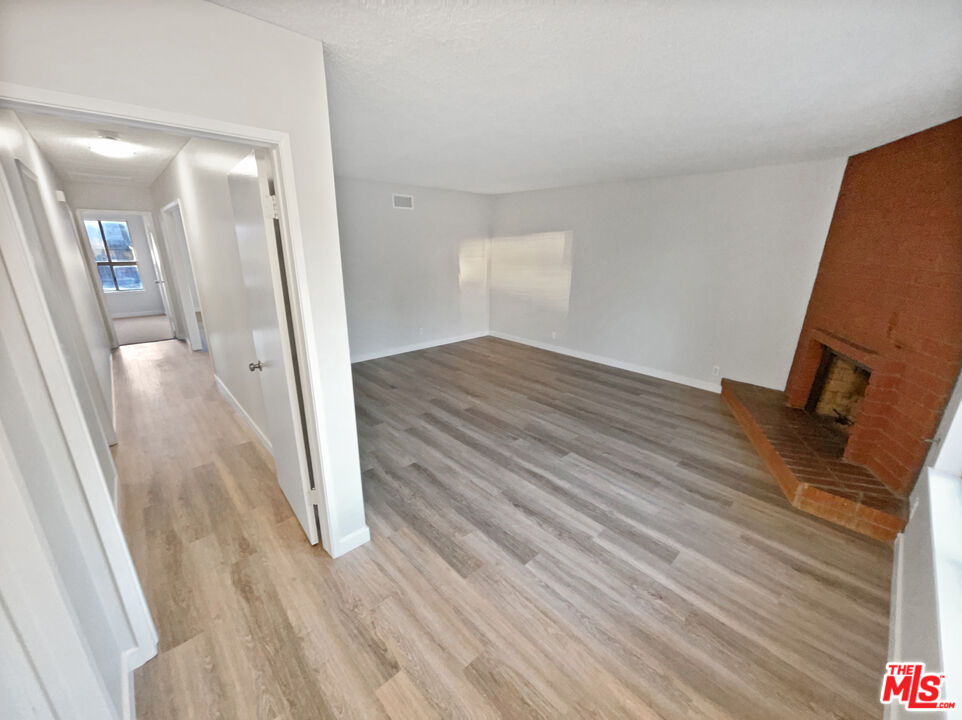 443 Pepper Tree Drive Brea, CA 92821 - Photo 11 of 26 a view of a hallway with wooden floor and staircase