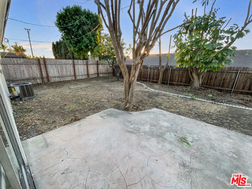 443 Pepper Tree Drive Brea, CA 92821 - Photo 24 of 26 a view of a backyard with large trees and wooden fence