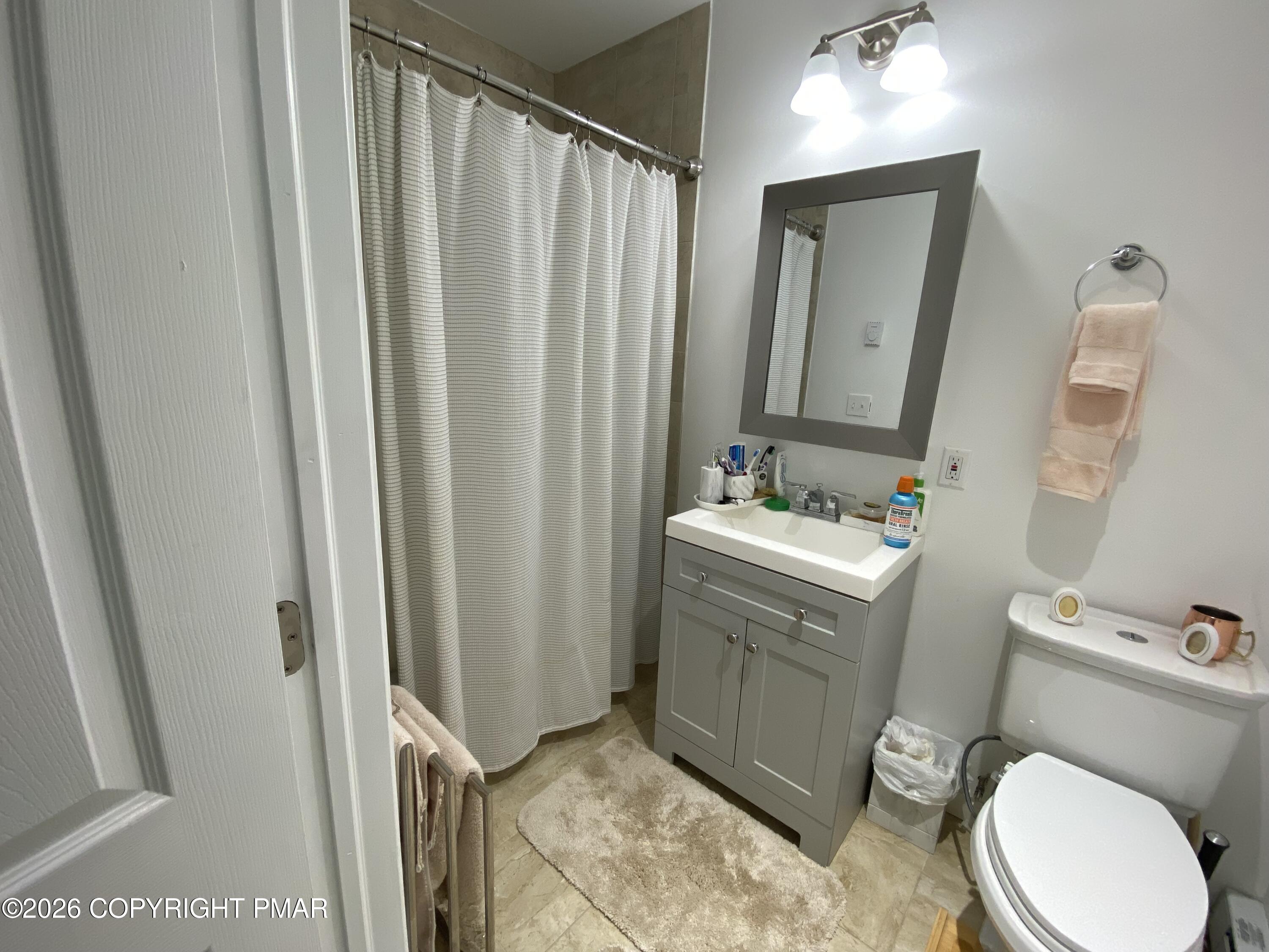 565 Cherry Lane Road East Stroudsburg, PA 18301 - Photo 12 of 16 a bathroom with a sink a toilet a mirror and shower