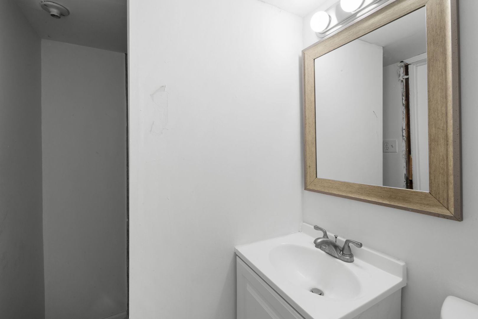 429 East 89th Street Chicago, IL 60619 - Photo 11 of 15 a bathroom with a sink and a mirror