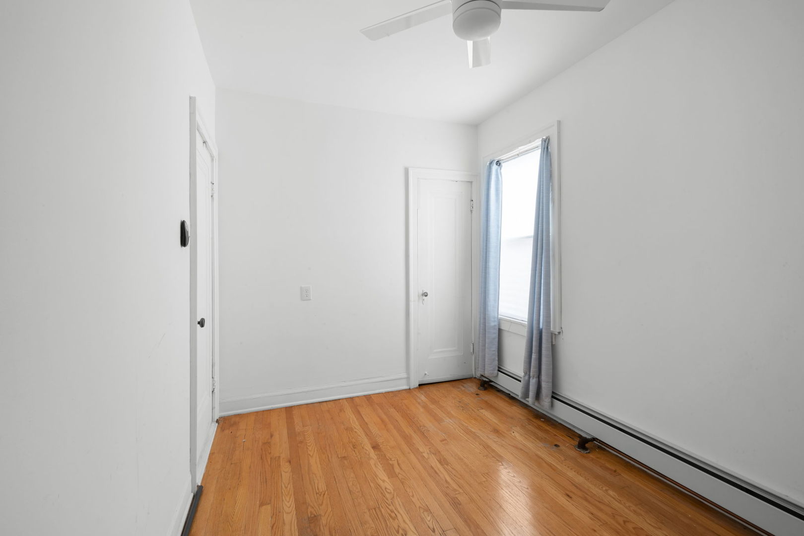 429 East 89th Street Chicago, IL 60619 - Photo 5 of 15 an empty room with wooden floor and windows