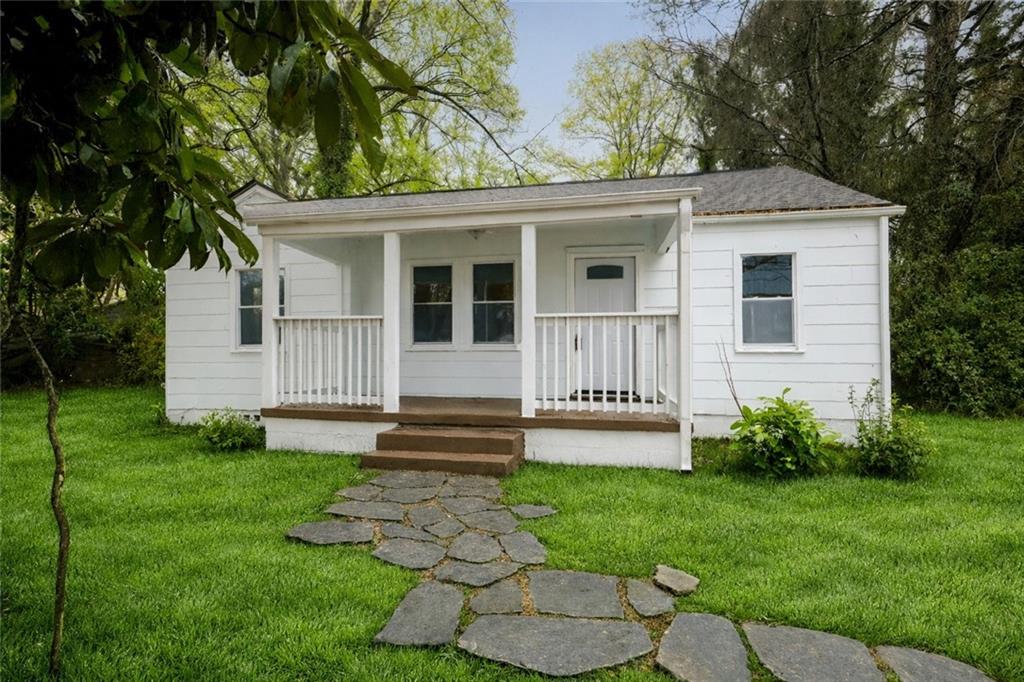 a view of a house with a yard and a garden