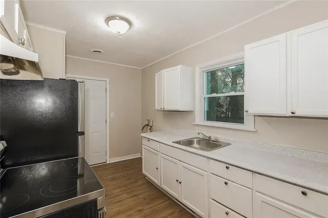 a kitchen with a sink and cabinets