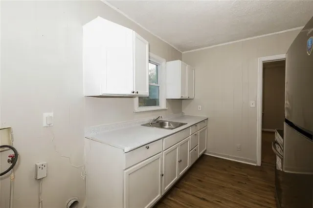a kitchen with a sink stove and cabinets