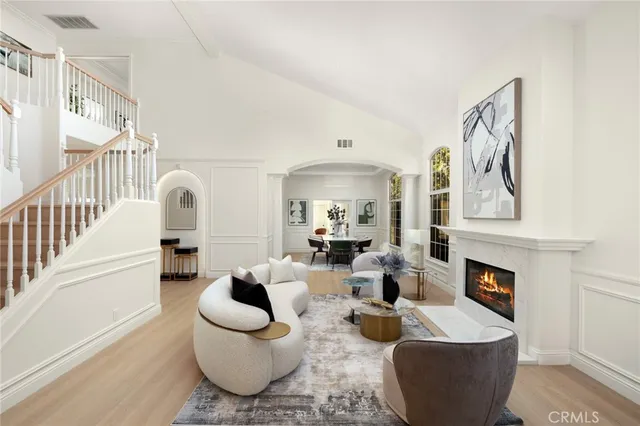 a living room with furniture a fireplace and a potted plant