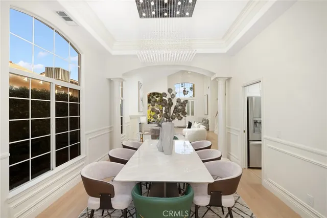 a view of a dining room with furniture and chandelier