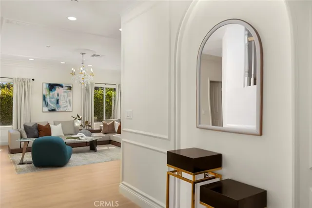 a living room with furniture potted plant and a large window