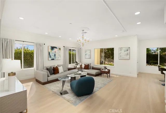 a living room with furniture potted plant and a chandelier