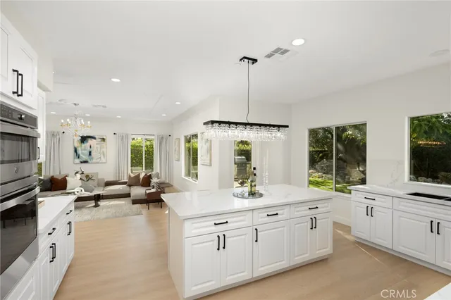a kitchen with stainless steel appliances a sink stove and cabinets