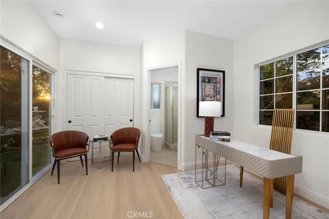 a spacious bedroom with a bed a couch and a window