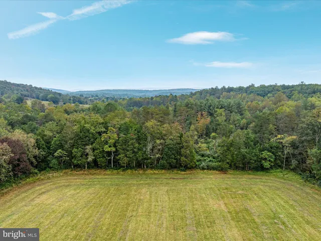 a view of big yard with an outdoor space