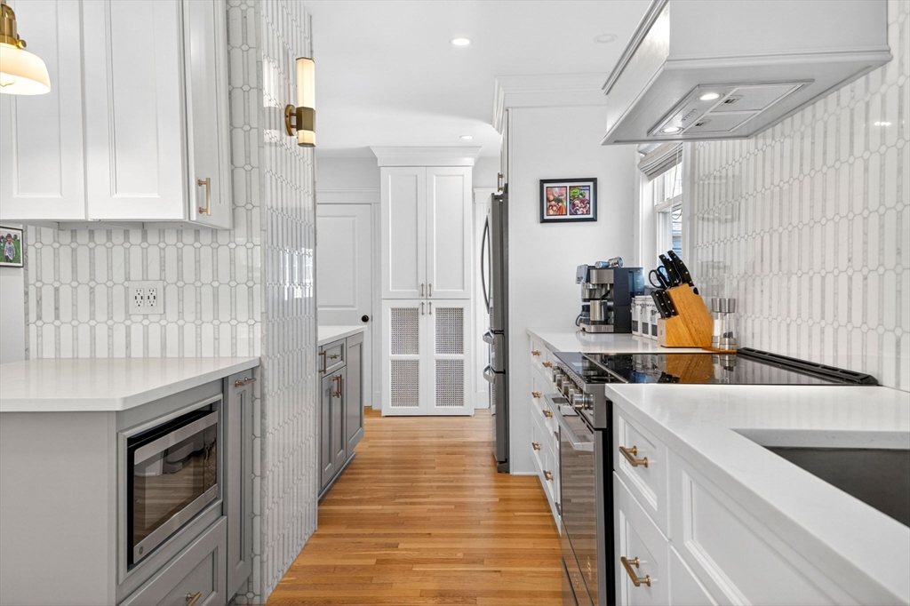 33 Bateswell Road Boston, MA 02124 - Photo 13 of 38 a kitchen with stainless steel appliances granite countertop a refrigerator and a sink