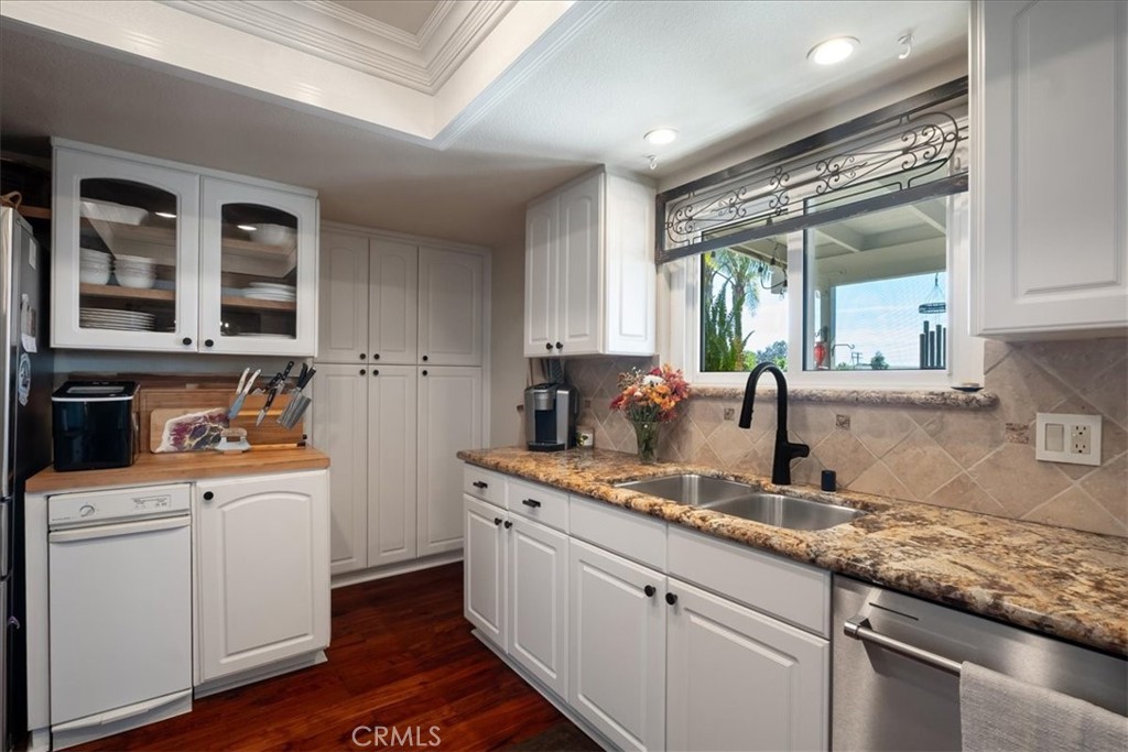 1321 June Street Fallbrook, CA 92028 - Photo 14 of 44 a kitchen with granite countertop a sink stove and cabinets