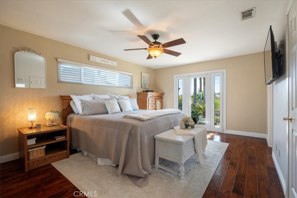 1321 June Street Fallbrook, CA 92028 - Photo 17 of 44 a spacious bedroom with a bed and a chandelier