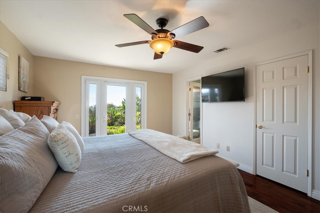 1321 June Street Fallbrook, CA 92028 - Photo 18 of 44 a bedroom with a large bed and a flat screen tv