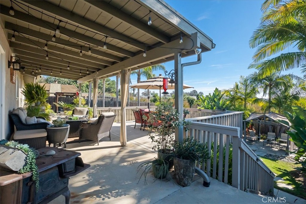 1321 June Street Fallbrook, CA 92028 - Photo 33 of 44 a view of a patio with table and chairs potted plants and palm tree