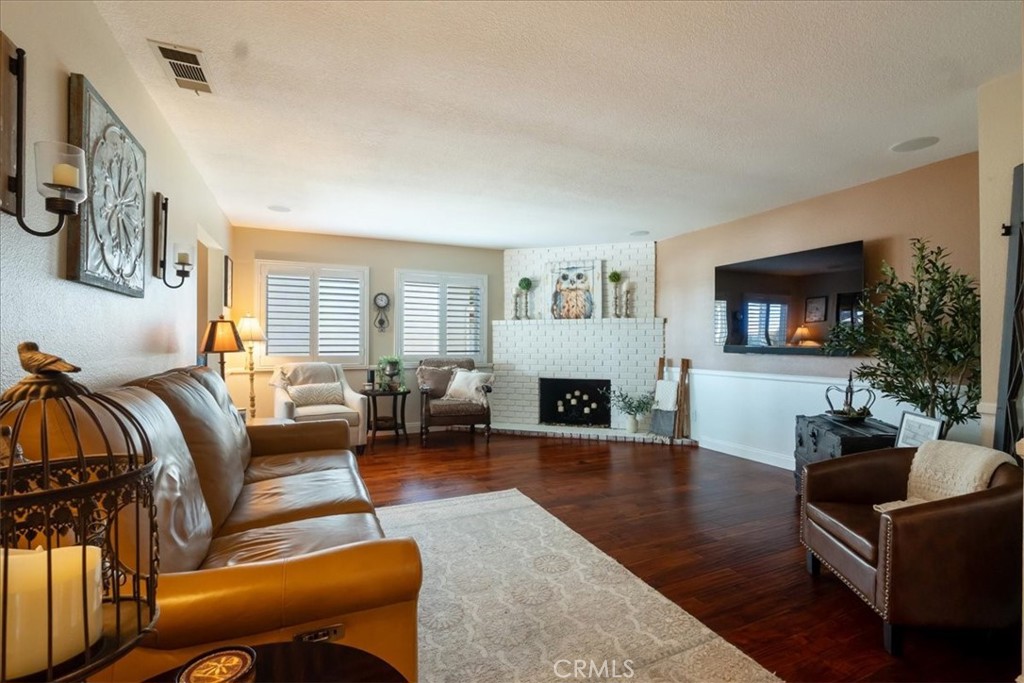 1321 June Street Fallbrook, CA 92028 - Photo 6 of 44 a living room with furniture a flat screen tv and a fireplace