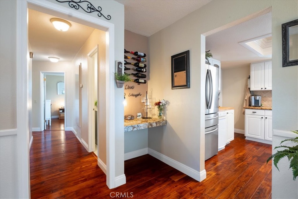 1321 June Street Fallbrook, CA 92028 - Photo 10 of 44 a view of a kitchen with a refrigerator a sink and dishwasher wooden floor
