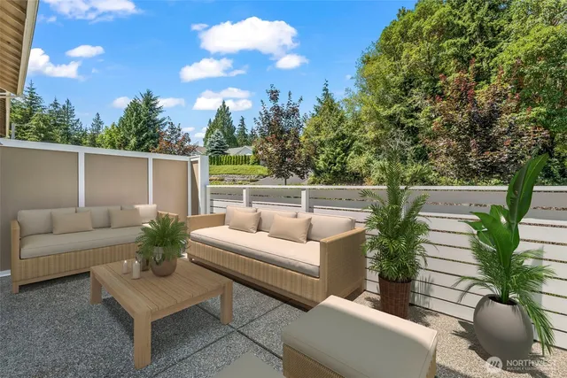 a view of a patio with couches table and chairs with potted plants and wooden fence