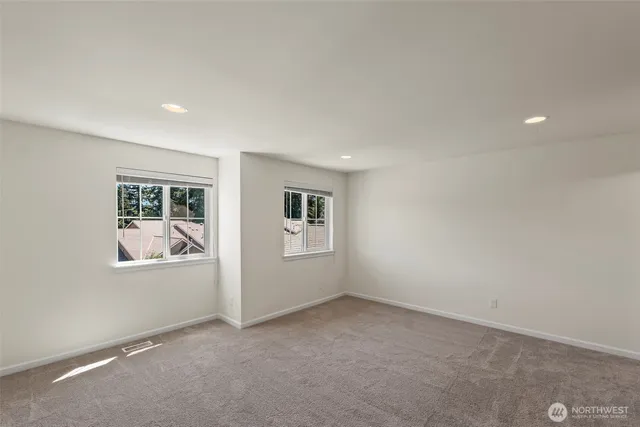 an empty room with windows and closet