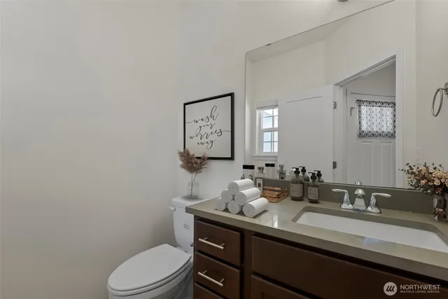 a bathroom with a sink toilet and mirror