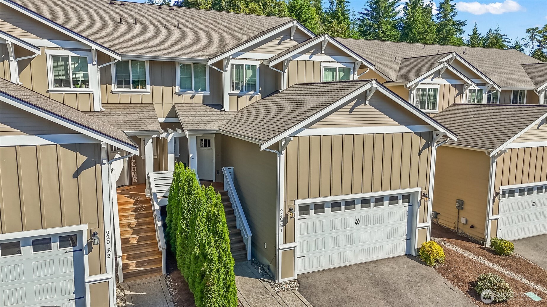 920 East Old Ranch Road, Unit E1 Allyn, WA 98524 - Photo 18 of 20 a front view of a house with a yard